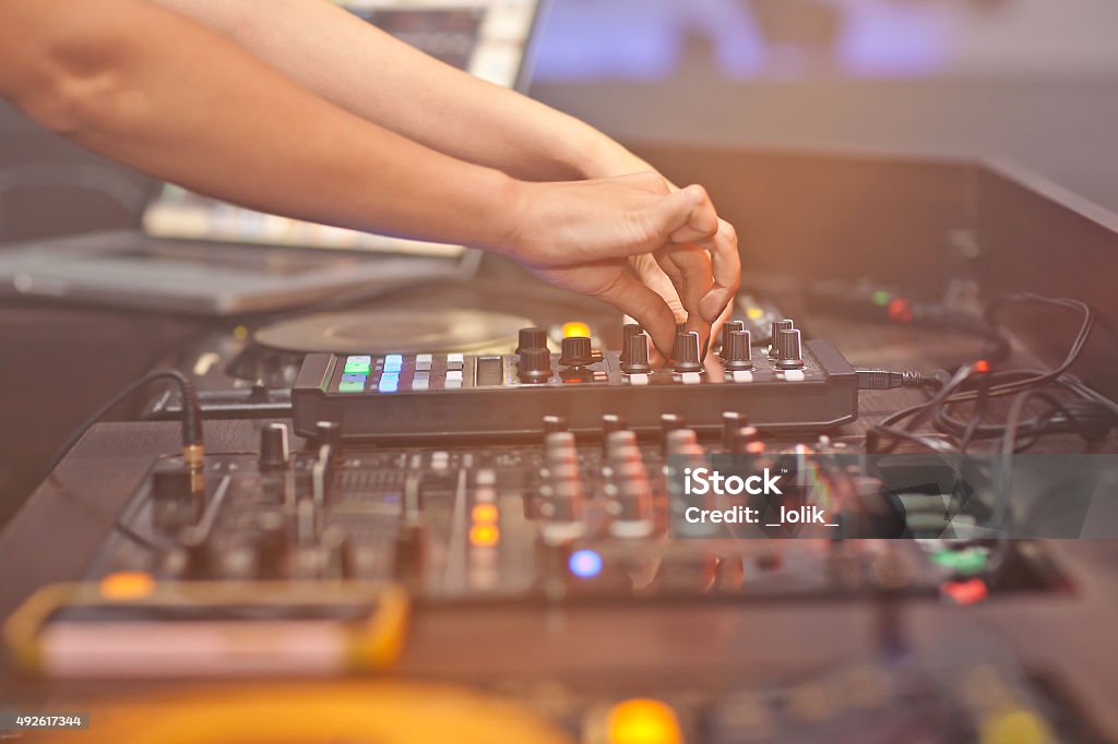 DJ mixing music on console at the night club 2015 Stock Photo