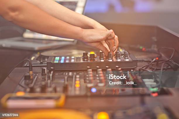 Dj Mixing Music On Console At The Night Club Stock Photo - Download Image Now - 2015, Adjusting, Arts Culture and Entertainment