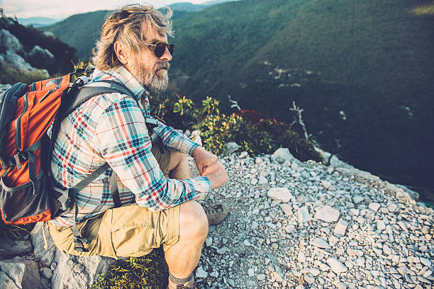 istock Senior Man Sitting and Resting in the Mountains 492617648