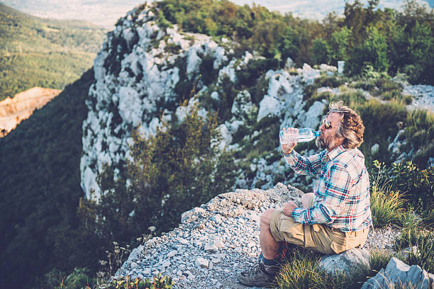 istock Senior Man Drinking Water from the Bottle in the Mountains 492617898