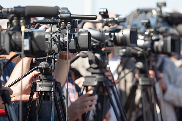 istock News conference. Filming an event with a video camera. 492618332