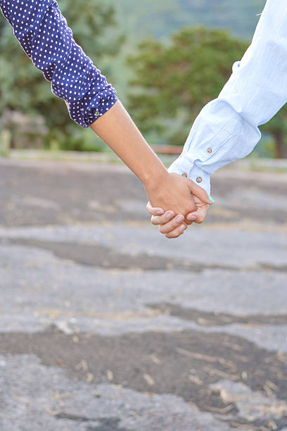 istock Couple holding hands outdoors 492618784