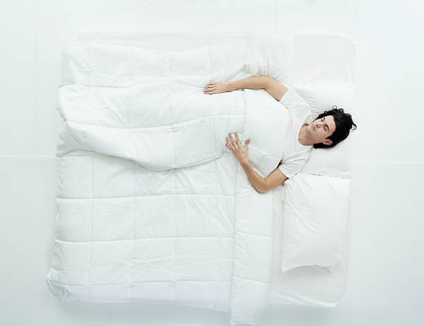 istock Above view of man sleeping on bed 492618892