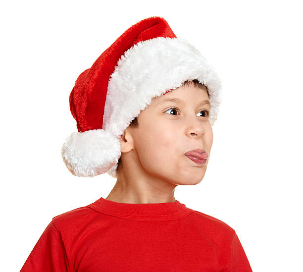 istock winter holiday christmas concept boy in santa hat on white 492620764