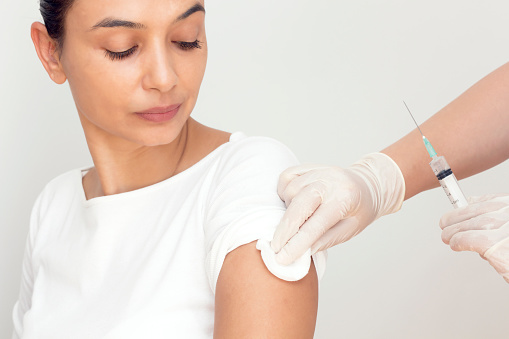 Nurse makes vaccination of patient in a clinic, horizontal