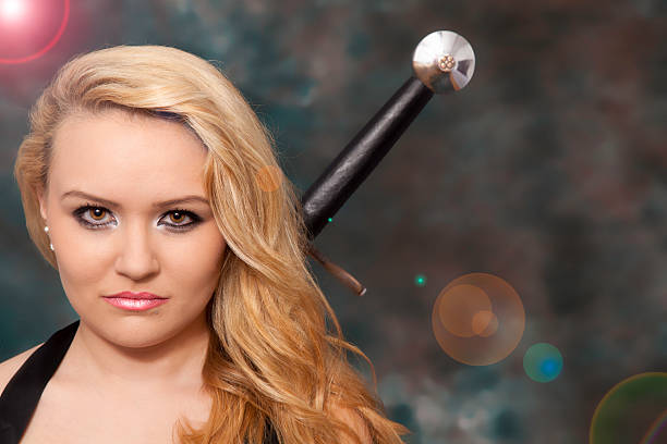 young beautiful blonde woman or girl with a sword behind the back