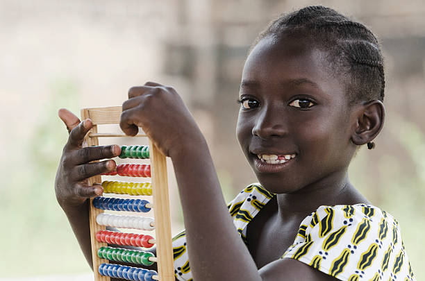 istock Black African Girl Playing with Abacus to Learn to Count 492622932
