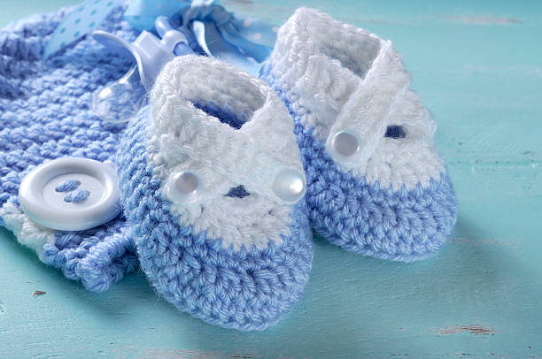 istock Baby boy blue white wool booties and bonnet close up 492624679