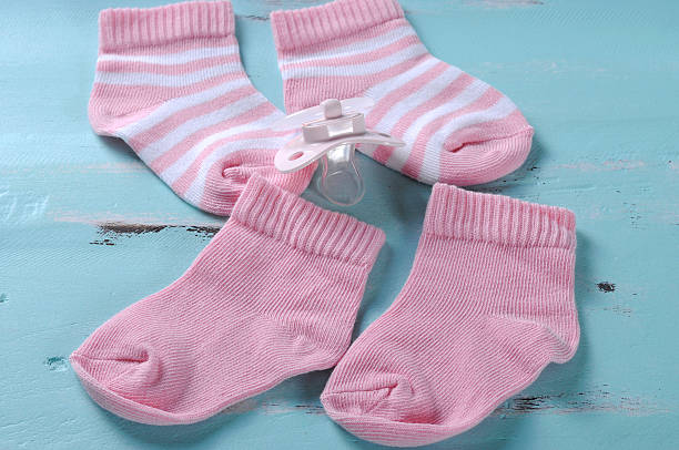 istock Baby girl nursery pink and white stripe socks 492624687