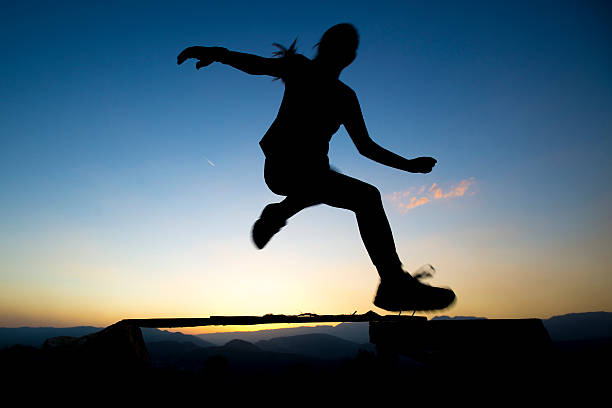 istock jumping over obstacles at sunset young girl day 492626048