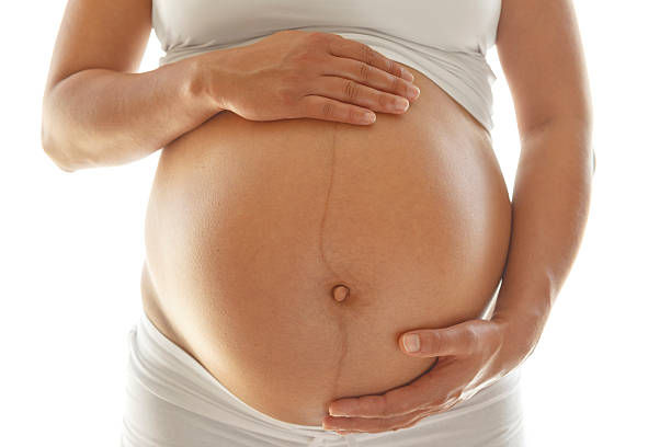istock Pregnant woman holding her belly 492626408