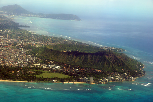 Aerial view of Diamondhead, Kapiolani Park, Waikiki, Natatorium, Kapahulu town, Pacific ocean, clouds, and on Oahu, Hawaii.