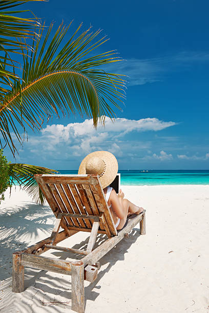 istock Young woman with tablet pc at the beach 492628245