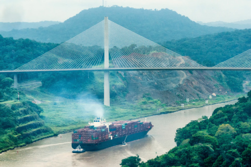 Cargo ship in transit of the Panama Canal passes under the Centenary Bridge, Panama