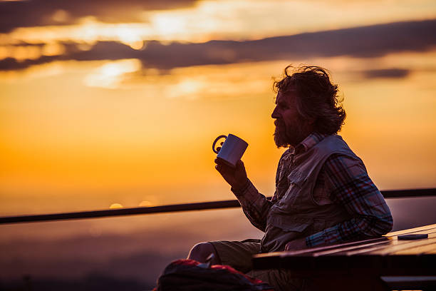 istock Man Drinking Coffee or Tea in the Mountains, Sunset 492629332