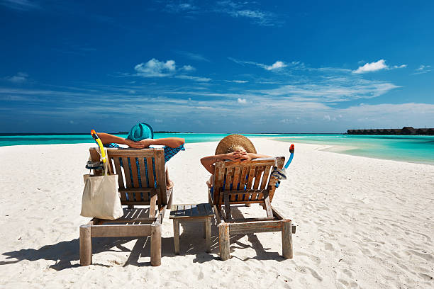 istock Couple relax on a beach at Maldives 492629549