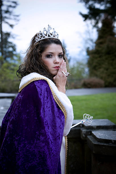 istock Beauty Queen Disheveled, Smoking a Cigarette with Robe, Scepter 492630108