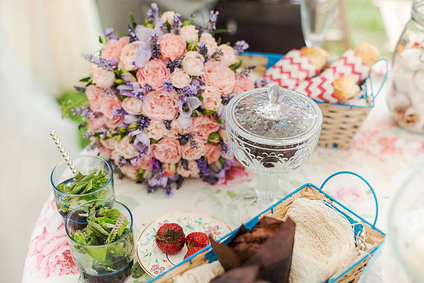 Served table outdoors. Flower arrangement with lavender and roses
