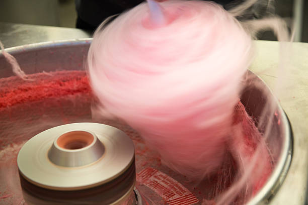 Pink Cotton Candy Pink cotton candy spinning fast as it is being made in a machine. Cotton Candy stock pictures, royalty-free photos & images