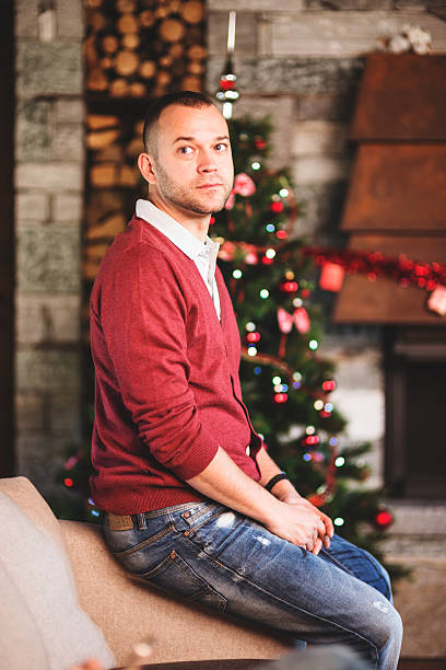 istock man sitting on the couch for christmas 492630602