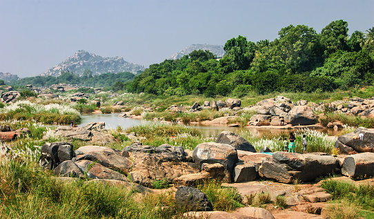 Tungabhadra River in Hampi area with Anjaneya hill in the background which is believed to be the birthplace of Hindu God Hanuman.
