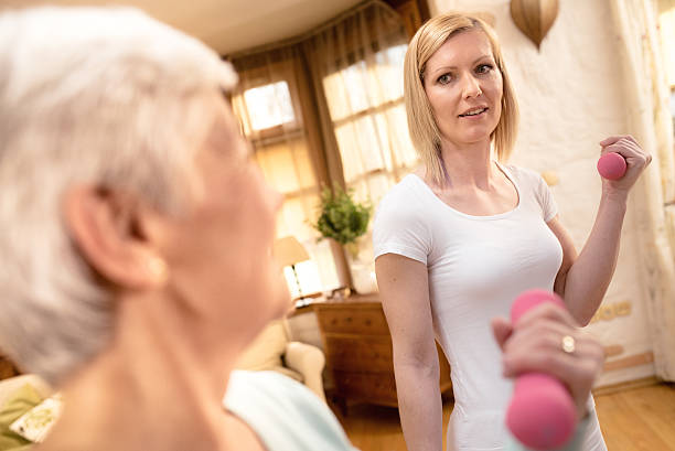 istock Young female personal trainer instructing senior woman 492631272