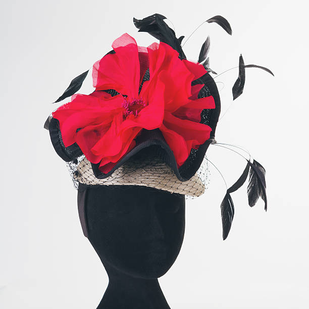 Red flower and black feathers races hat stock photo
