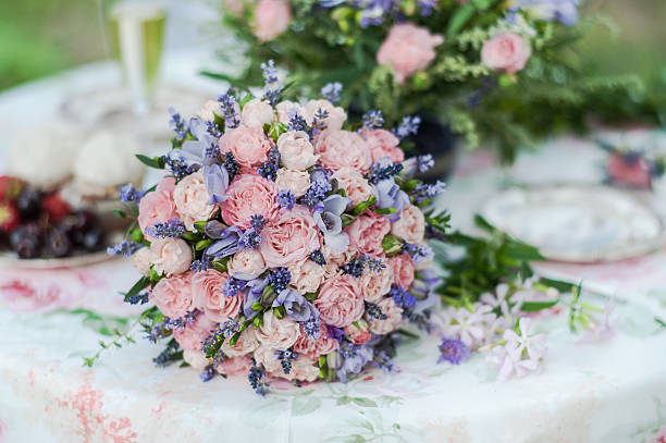 istock Served table outdoors. Flower arrangement with lavender and roses 492631904