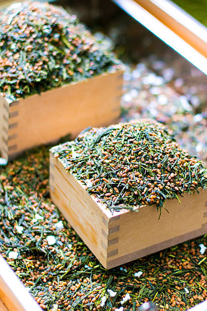 Genmai Tea Genmai tea is Japanese green tea blended with popped rice. Focus on mound of tea in the foreground. genmai stock pictures, royalty-free photos & images