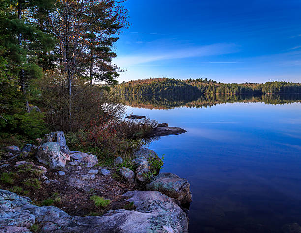 istock Rocky shoreline with mirror like lake 492641546