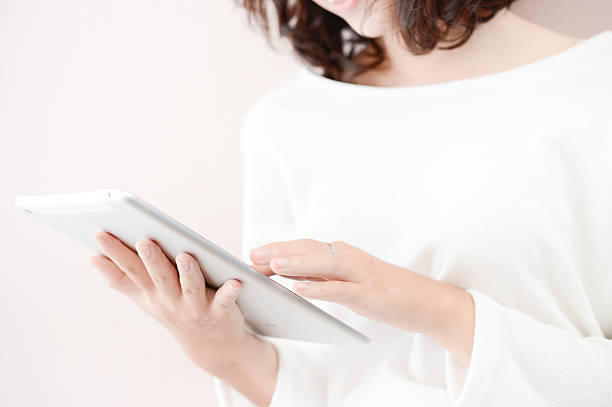istock smile young asian woman use tablet computer 492646972