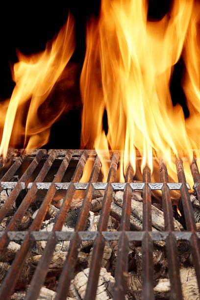 istock Hot Barbecue Grill With Vibrant Flame On The Black Background 492648476