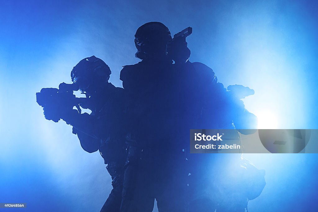 Police officers SWAT Police officers SWAT in black uniform in the smoke studio shot Police Force Stock Photo