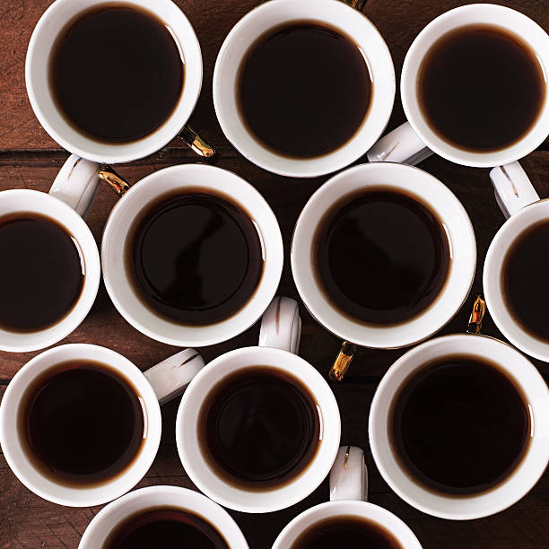 istock Wooden background with white cup of coffee 492648872