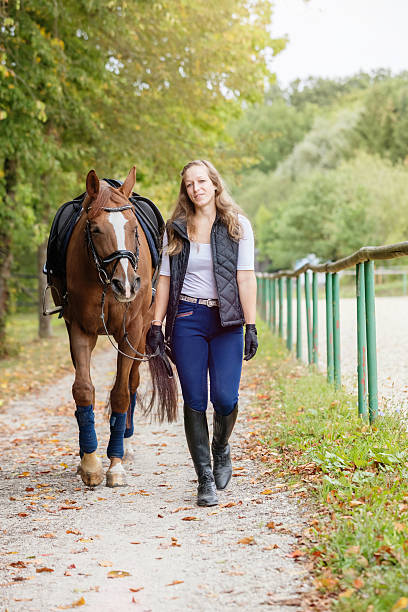 istock Woman bringing her horse back from the ride 492651178