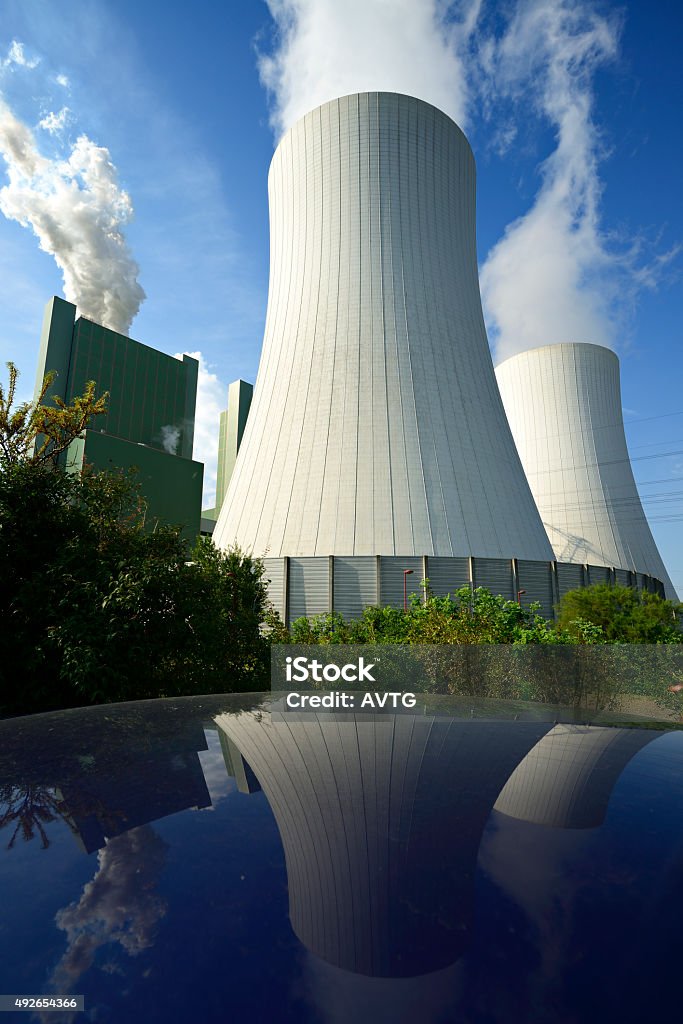 Coal Power Plant Smoking and Steaming against Blue Sky Nuclear Power Station Stock Photo