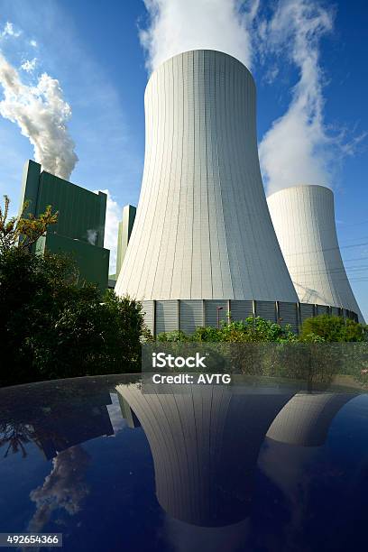 Coal Power Plant Smoking And Steaming Against Blue Sky Stock Photo - Download Image Now