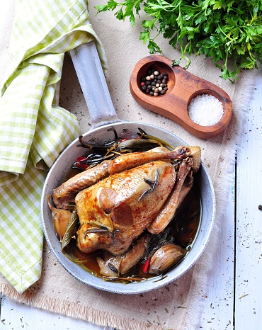 roast pigeon with Cassoulet beans, onions, bacon, carrots, broccoli, rosemary