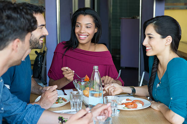 istock Smiling friends eating together 492655542