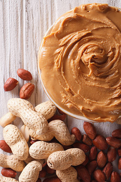 istock Tasty peanut butter in a bowl macro vertical top view 492655600