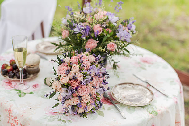 istock Served table outdoors. Flower arrangement with lavender and roses. Wedding 492655740