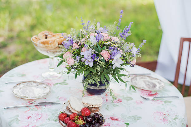 istock Served table outdoors. Flower arrangement with lavender and roses. Wedding 492655944