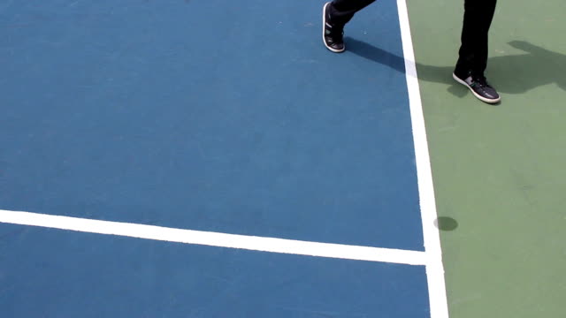 Judge look at mark on blue hard tennis surface