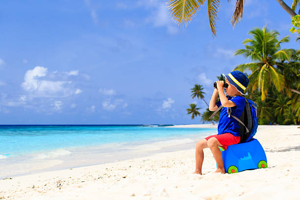 little boy travel on summer tropical beach