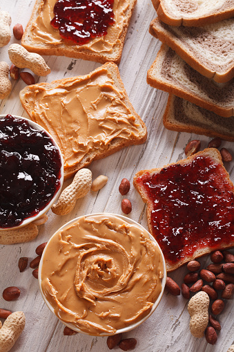 Sandwiches with peanut butter and jelly on the table. vertical