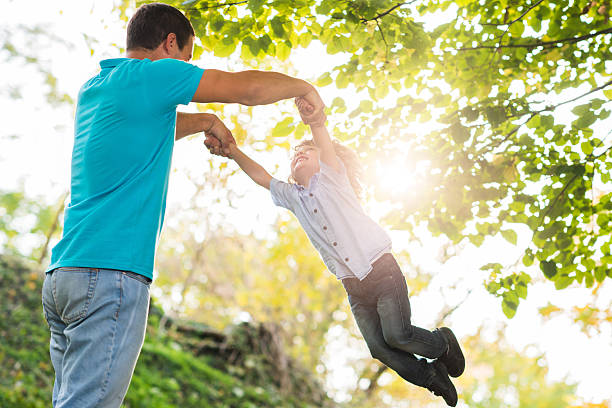 istock Father spinning his son in the park and having fun. 492666700