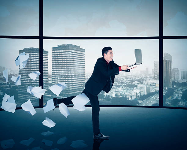 Asian business man running with laptop