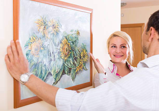 istock Couple hanging art picture in frame 492669946