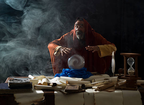 istock Blind fortune teller in fantastical costume using crystal ball 492670010
