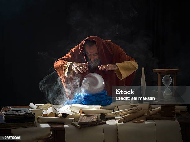 Fortune Teller In Fantastical Costume Using Crystal Ball Stock Photo - Download Image Now